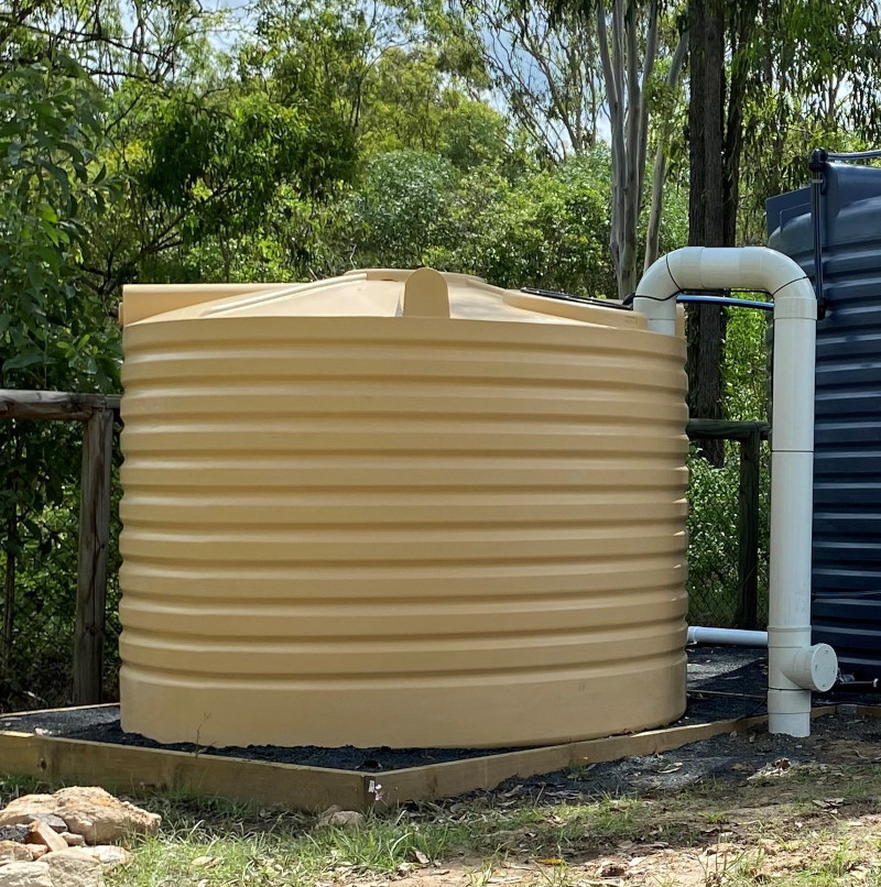 Water tank standing next to trees