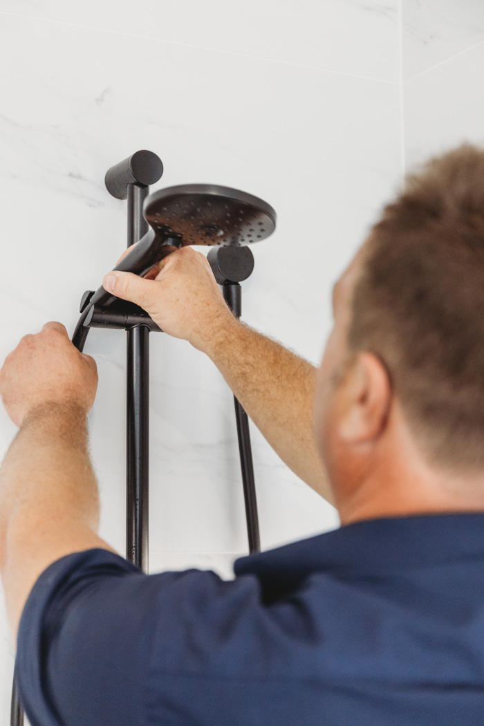 assure plumber repairing and installing shower head