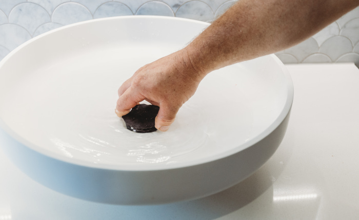 assure plumber fixing blocked sink