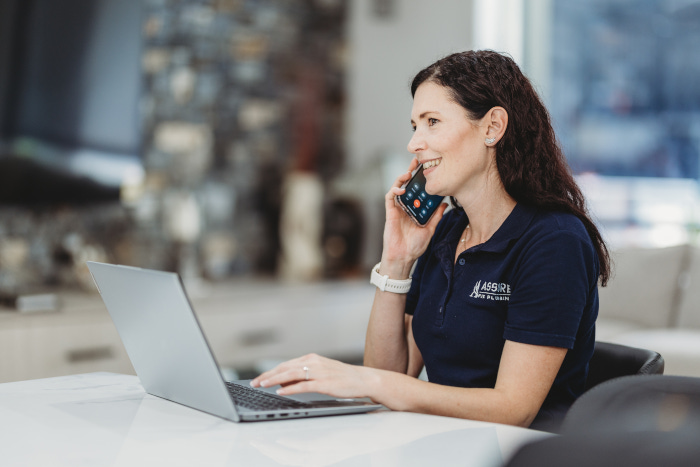 assure fix plumbing receptionist on the phone with a customer