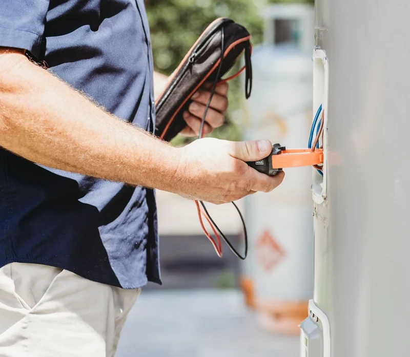 Assure Fix plumber performing maintenance on a residential hot water system in Ipswich.