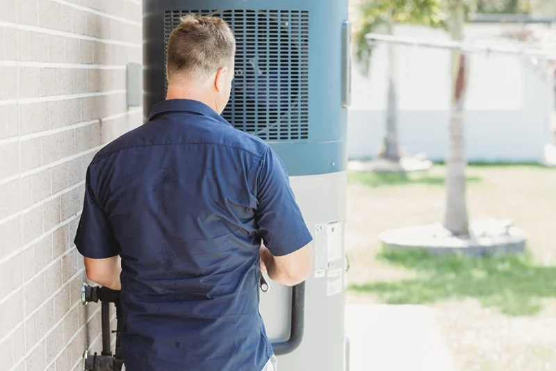 Assure Fix plumber inspecting hot water system during emergency repair in Ipswich.