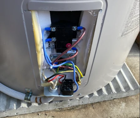 Hot water system with exposed wiring during inspection for hot water replacement in Ipswich by a licensed plumber.