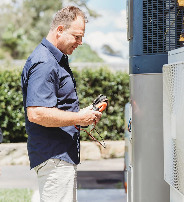 Plumber inspecting hot water system for upgrade and energy efficiency