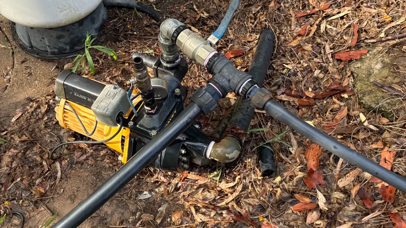 Outdoor plumbing pipework inspection during annual plumbing inspection service